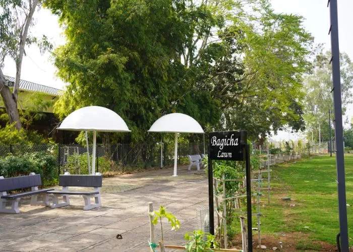 Garden seating area surrounded by greenery at Choice Resort Bhopal