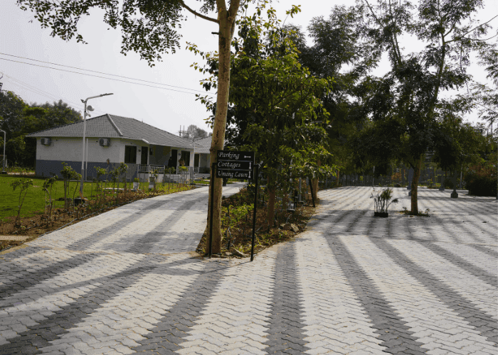 Scenic pathway leading to cottages at Choice Resort Bhopal
